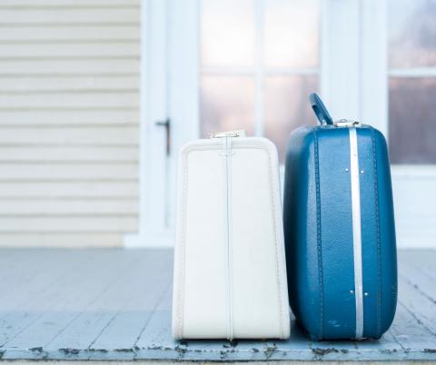 Photo of two suitcases on a doorstep