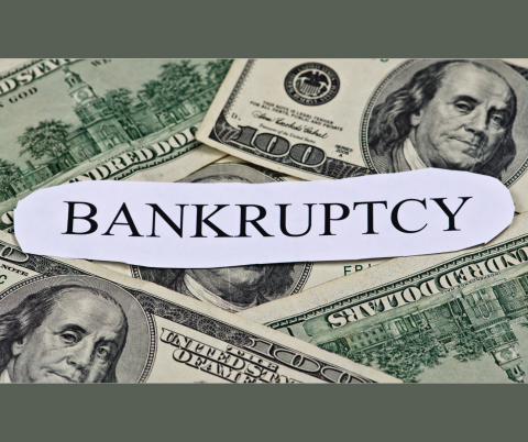 Photo of 100-dollar bills and the word Bankruptcy.